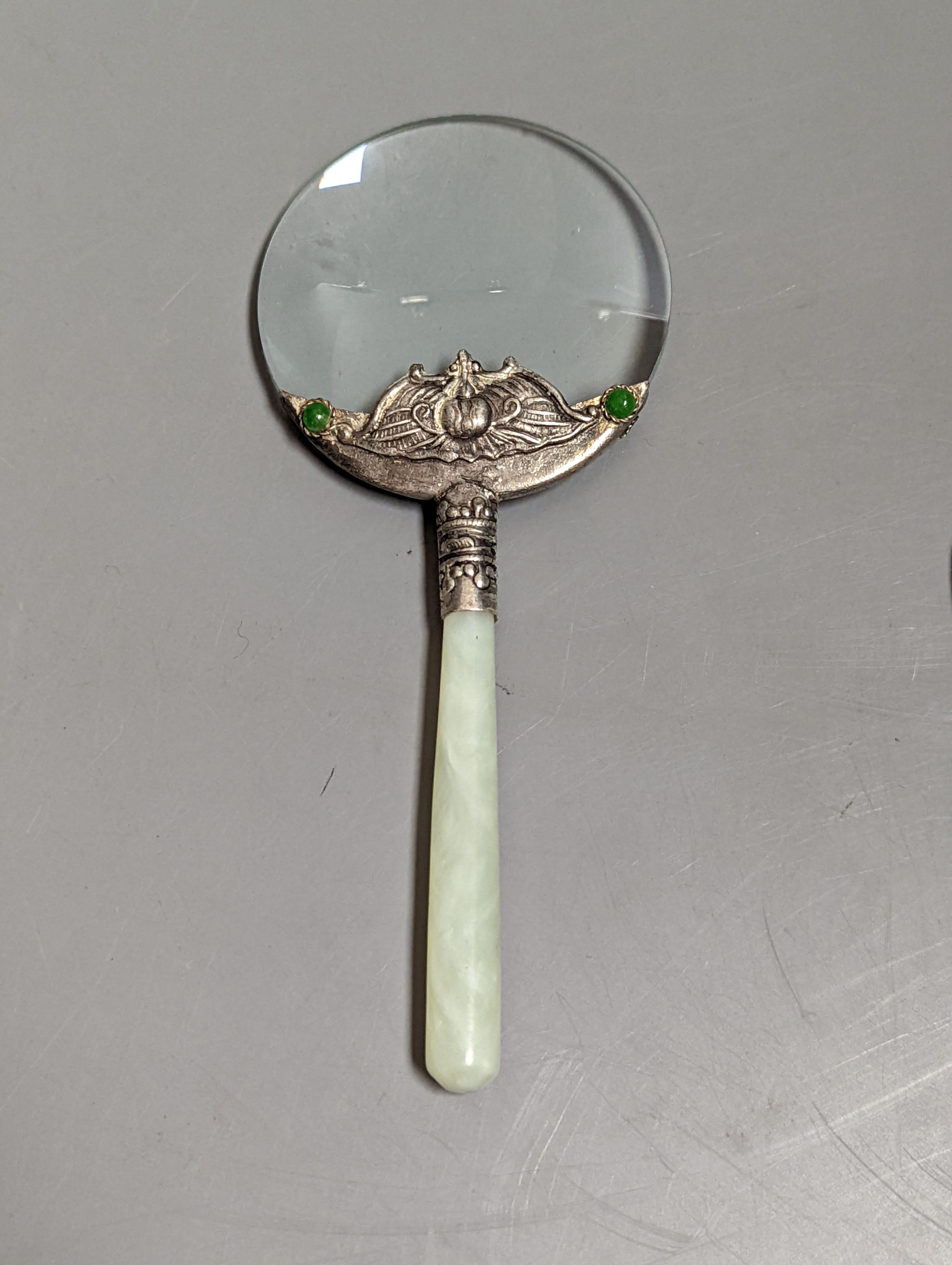 A Chinese bowenite jade handled magnifying glass, (14 cms long) and a jadeite peacock plaque